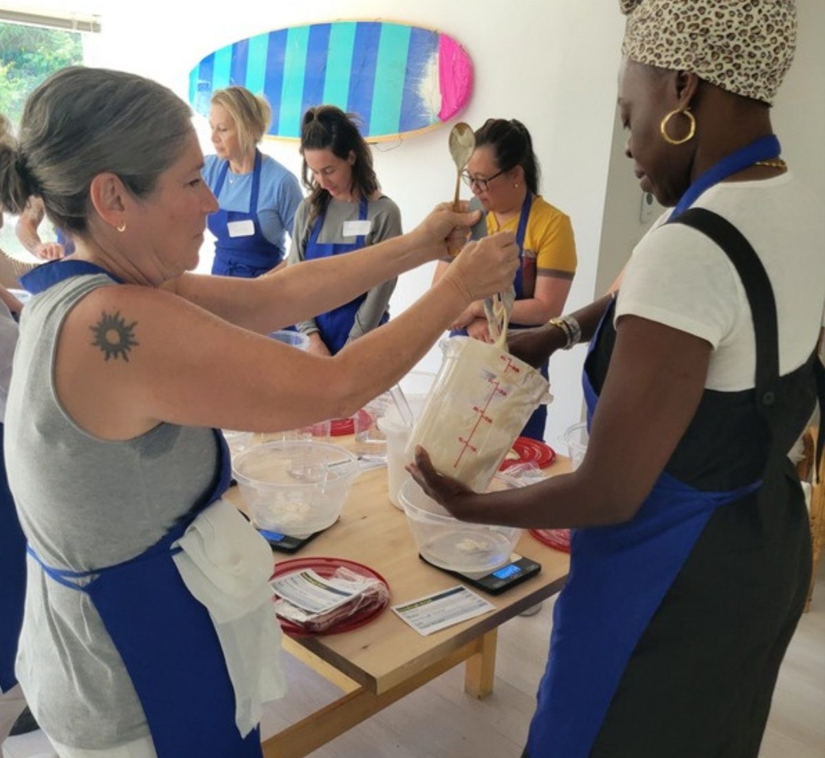 Guests shaping dough together during a hands-on sourdough class